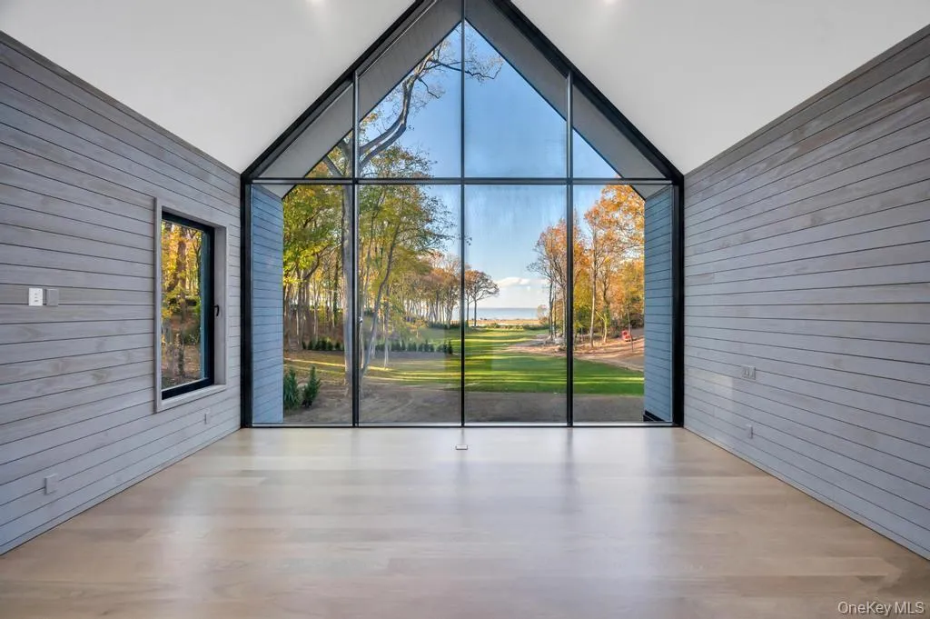 Unfurnished sunroom featuring vaulted ceiling and a water view Unfurnished sunroom featuring vaulted ceiling and a water view