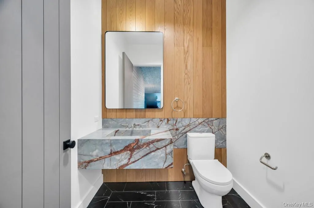 Bathroom with vanity and wooden walls Bathroom with vanity and wooden walls