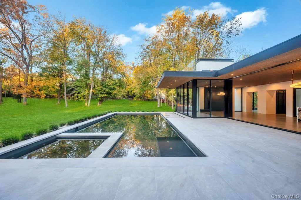View of swimming pool with a yard, a sunroom, a patio area, and a pool with connected hot tub View of swimming pool with a yard, a sunroom, a patio area, and a pool with connected hot tub