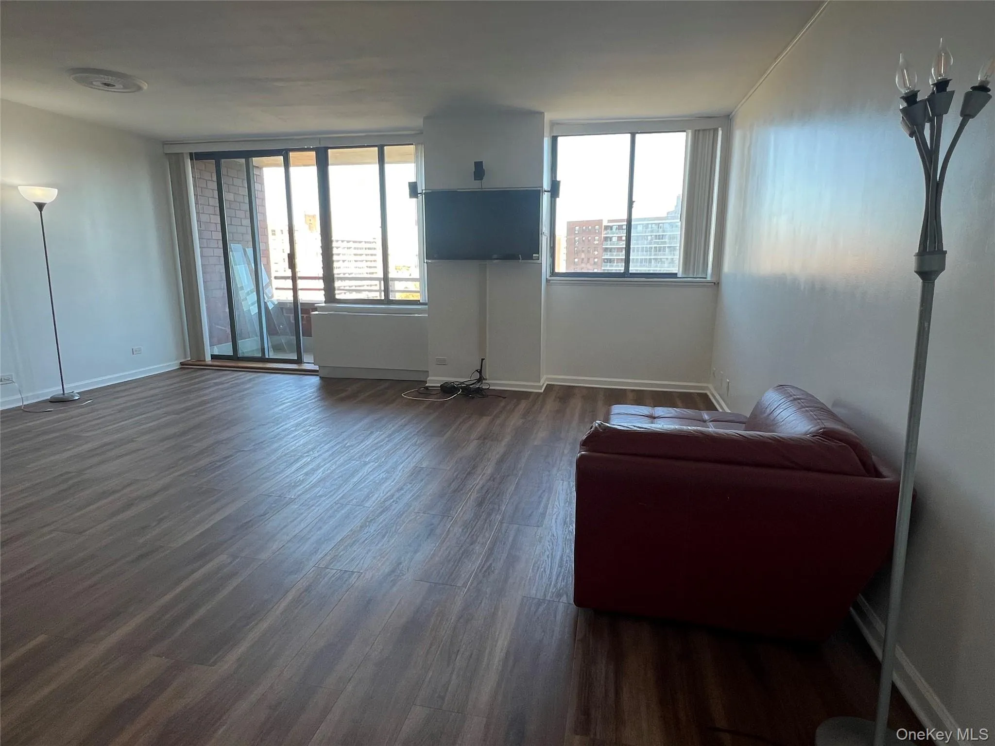 Living room with baseboards and dark wood-type flooring Living room with baseboards and dark wood-type flooring