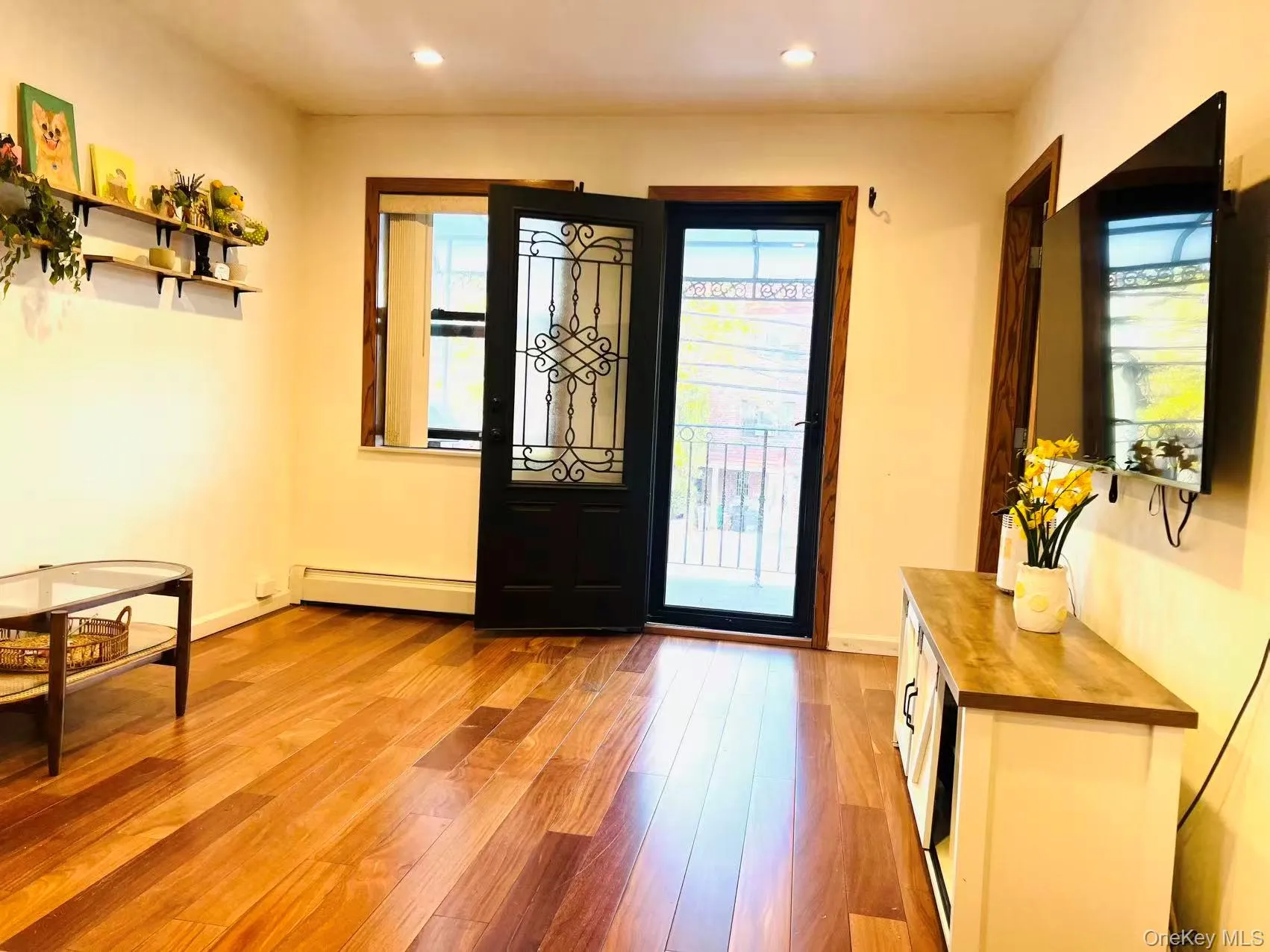Foyer with light wood-type flooring, baseboard heating, and recessed lighting Foyer with light wood-type flooring, baseboard heating, and recessed lighting