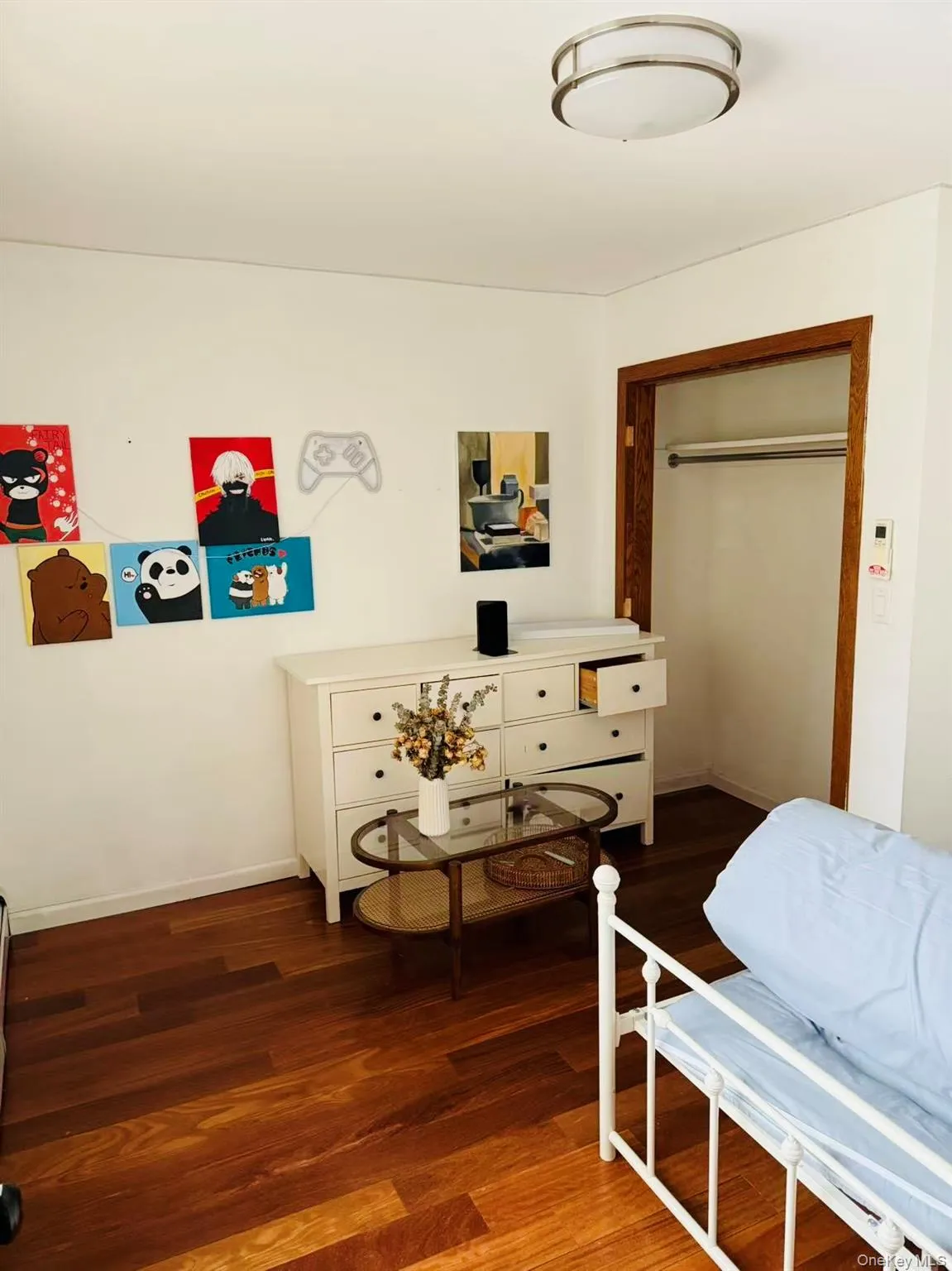 Living area with dark wood-style flooring and baseboards Living area with dark wood-style flooring and baseboards