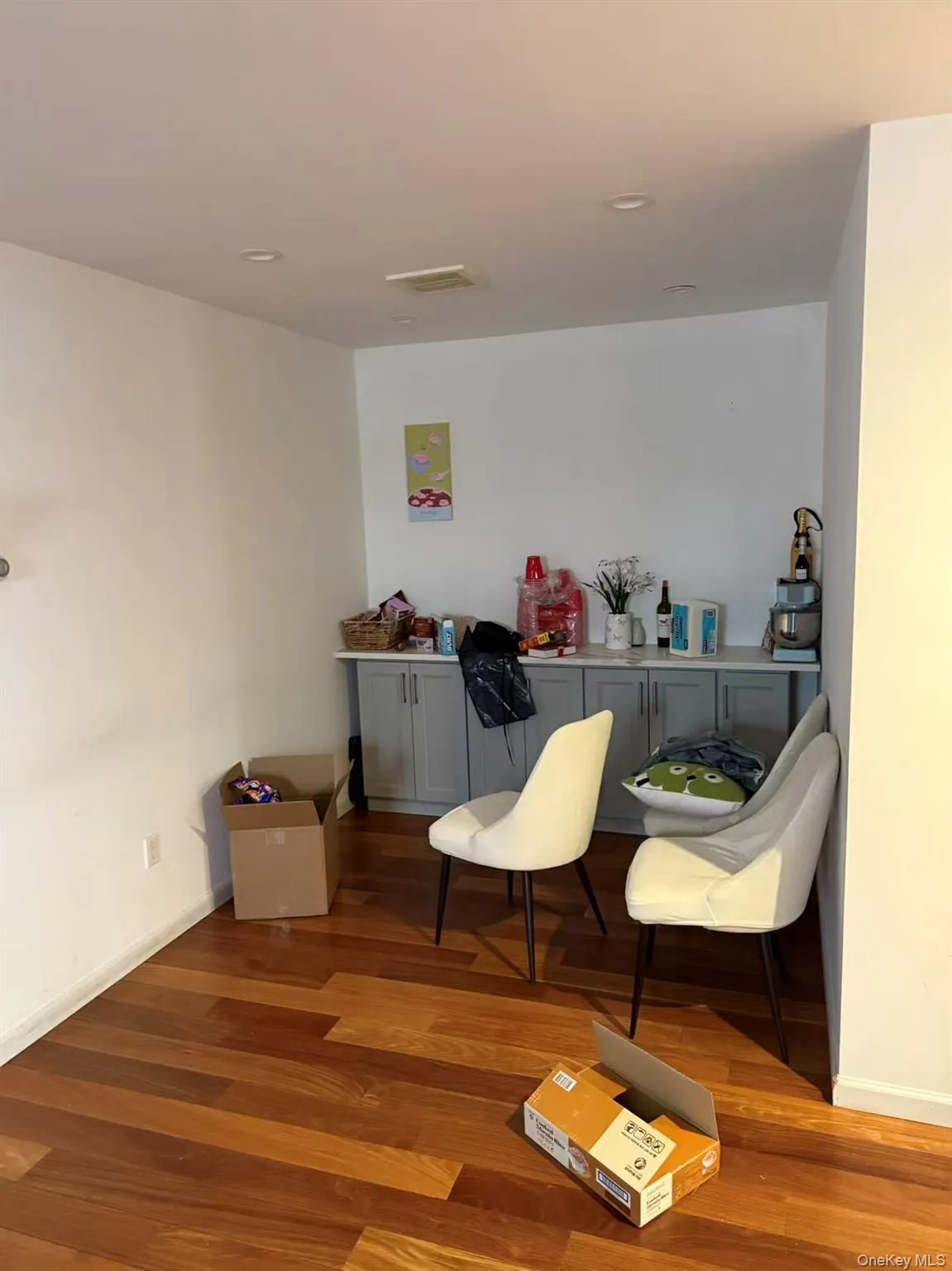 Sitting room with wood finished floors and baseboards Sitting room with wood finished floors and baseboards