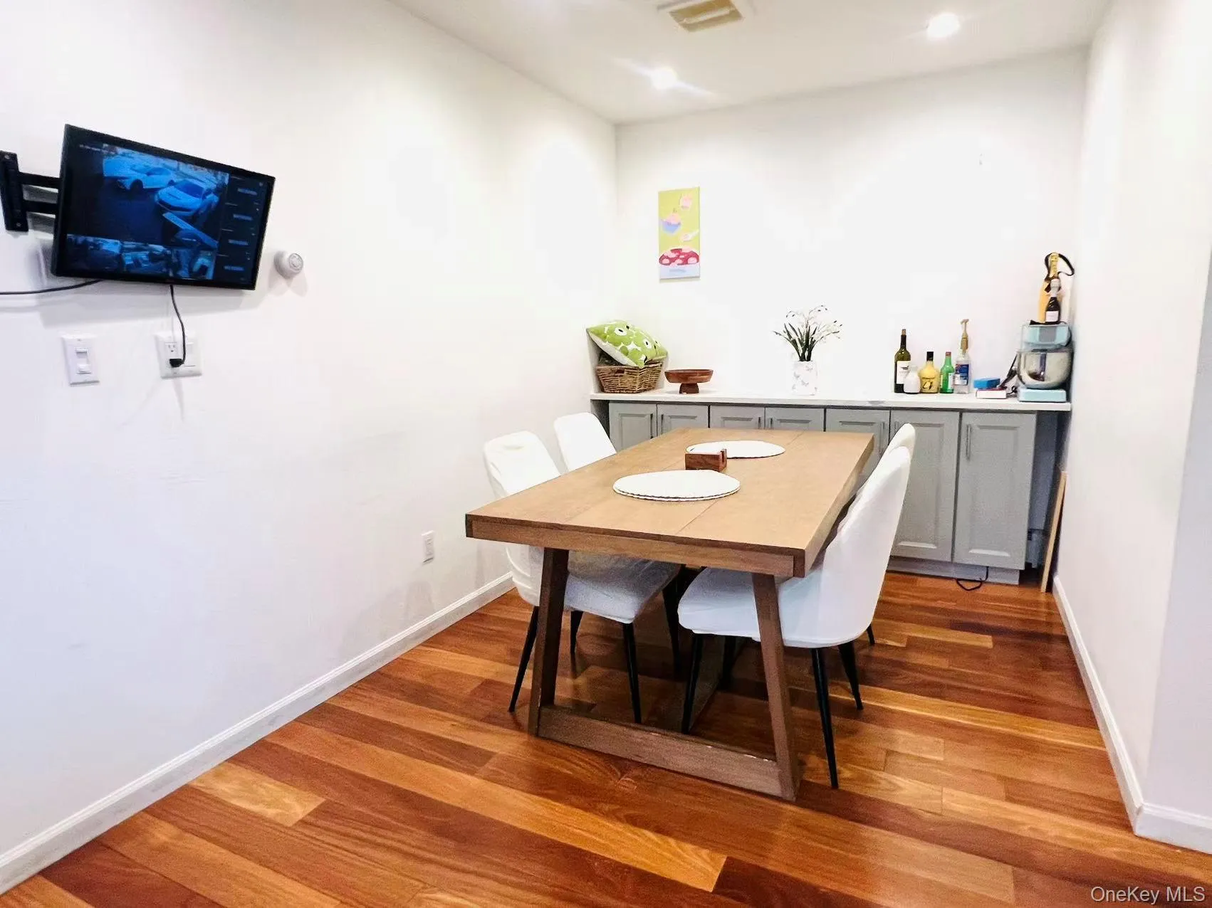 Dining room featuring dark wood-type flooring and recessed lighting Dining room featuring dark wood-type flooring and recessed lighting