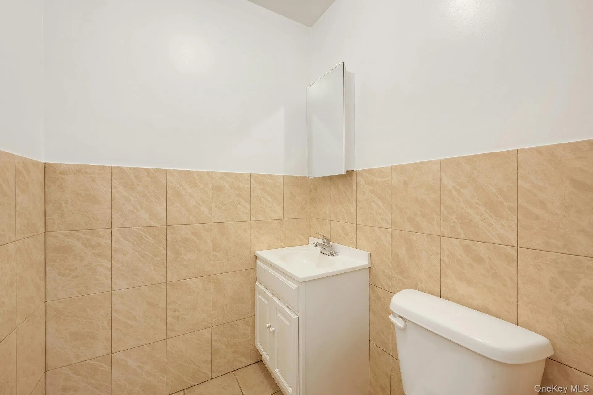 Half bath with vanity and tile walls Half bath with vanity and tile walls