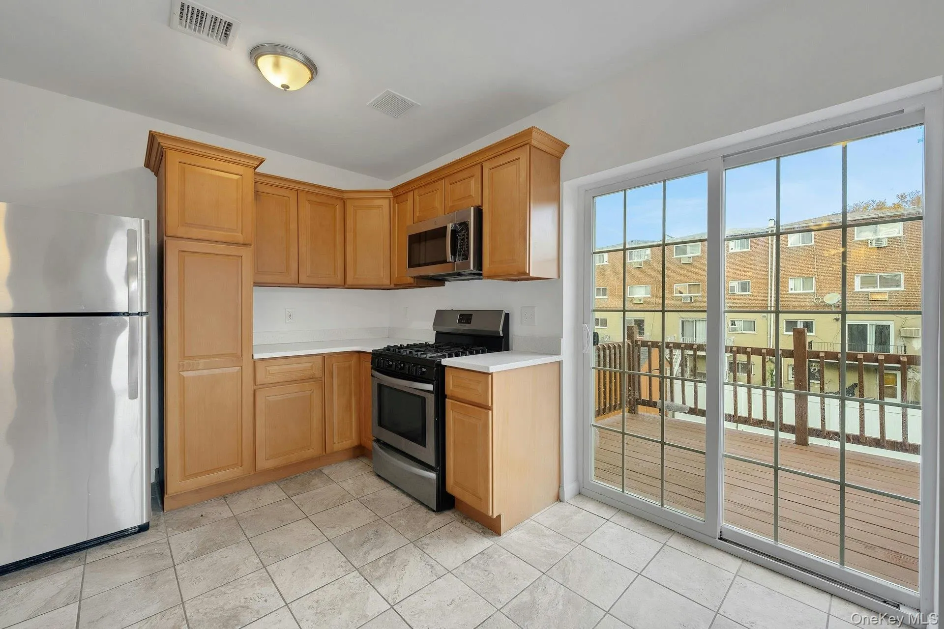 Kitchen with sliding doors to deck for entertaining and BBQ Kitchen with sliding doors to deck for entertaining and BBQ