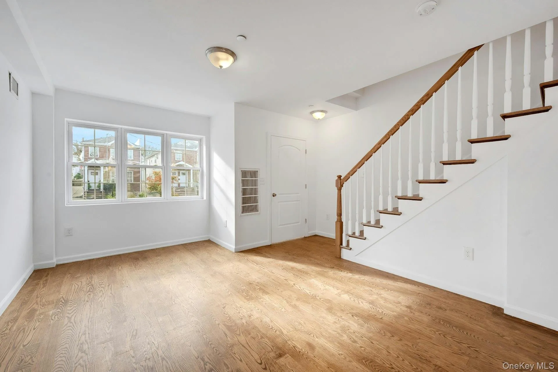 Living room with wood floors and plenty of natural sunlight flowing in. Living room with wood floors and plenty of natural sunlight flowing in.
