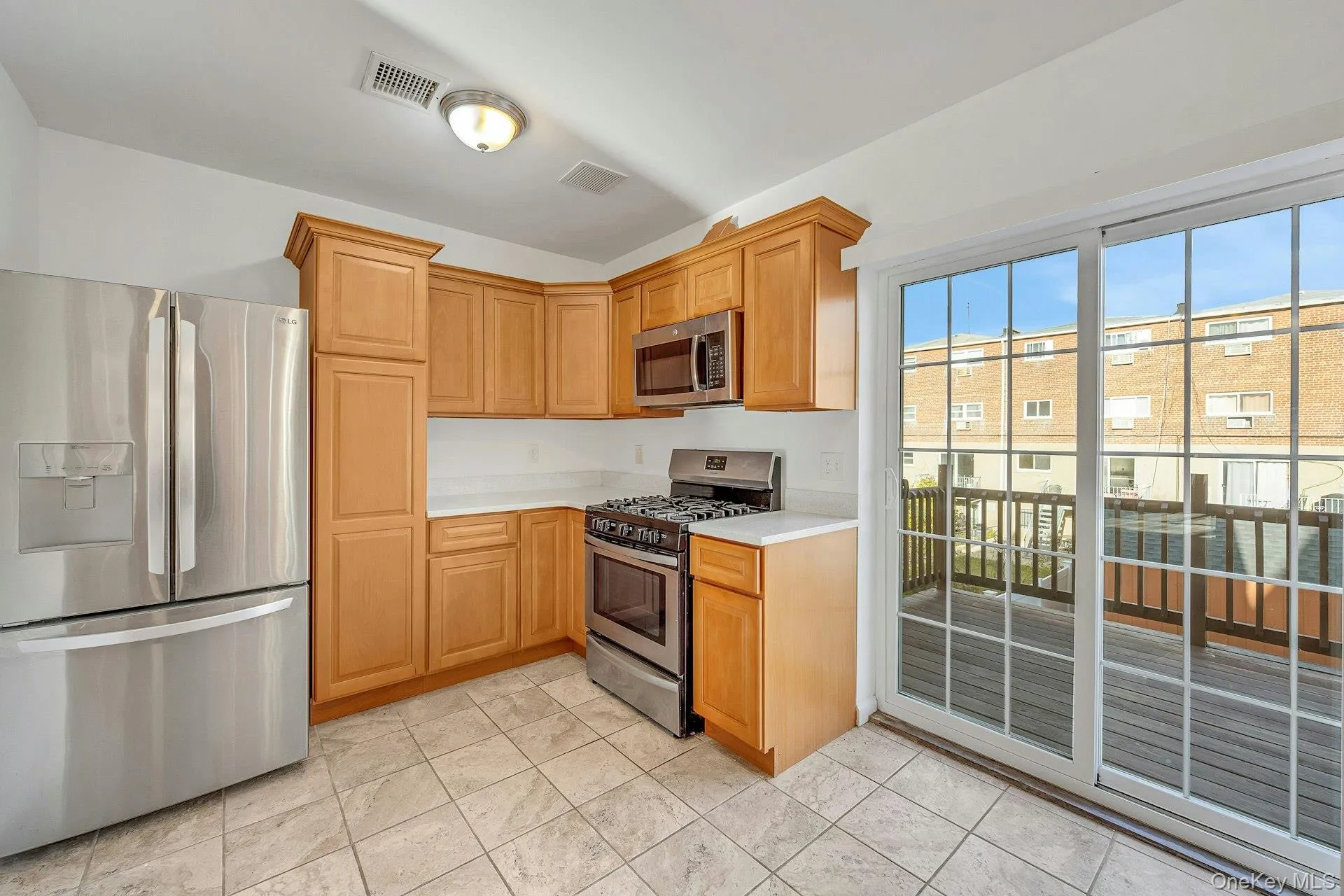Kitchen with sliding doors to deck for entertaining and BBQs Kitchen with sliding doors to deck for entertaining and BBQs