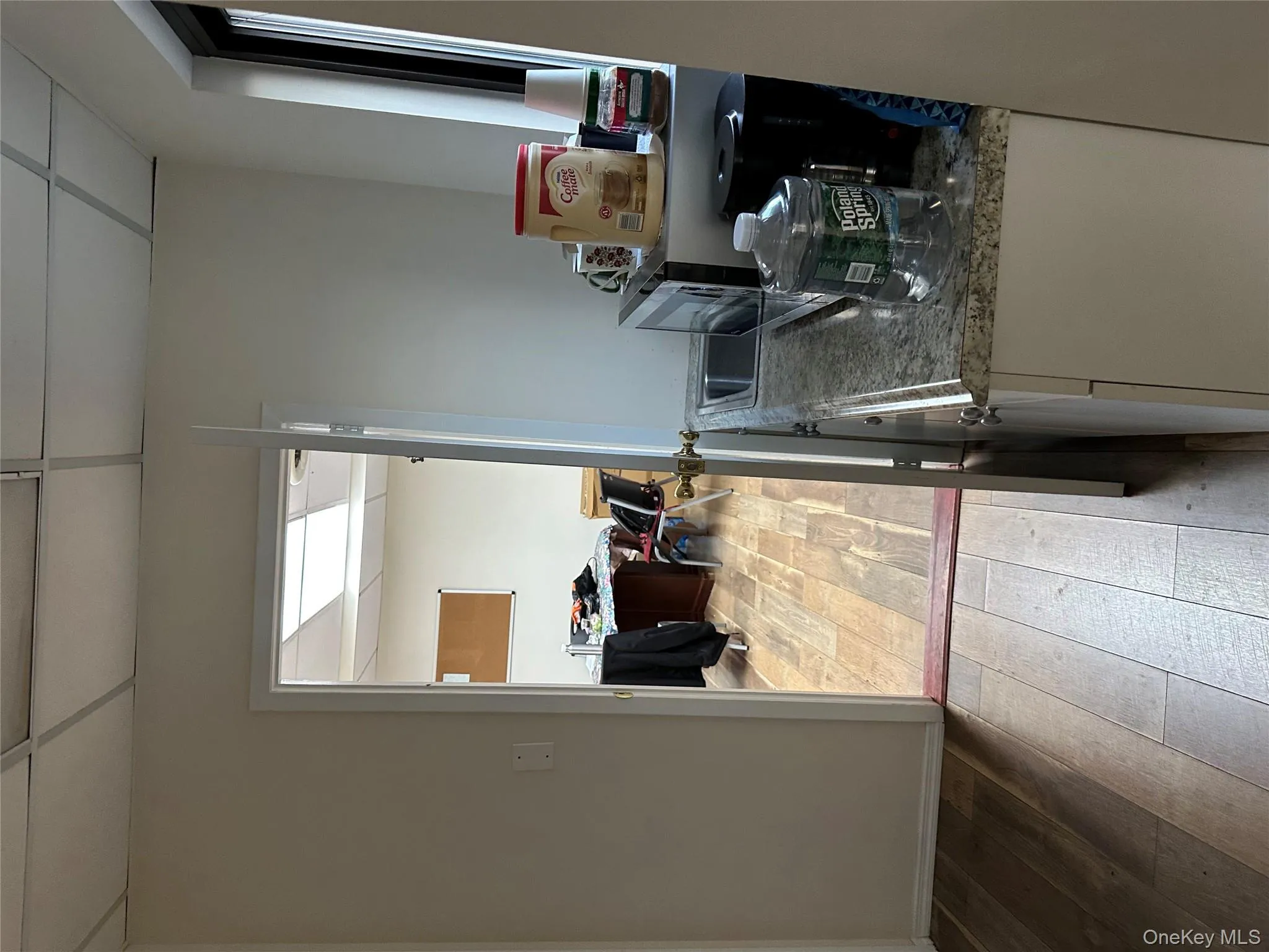 Kitchen featuring a drop ceiling and light wood-type flooring Kitchen featuring a drop ceiling and light wood-type flooring