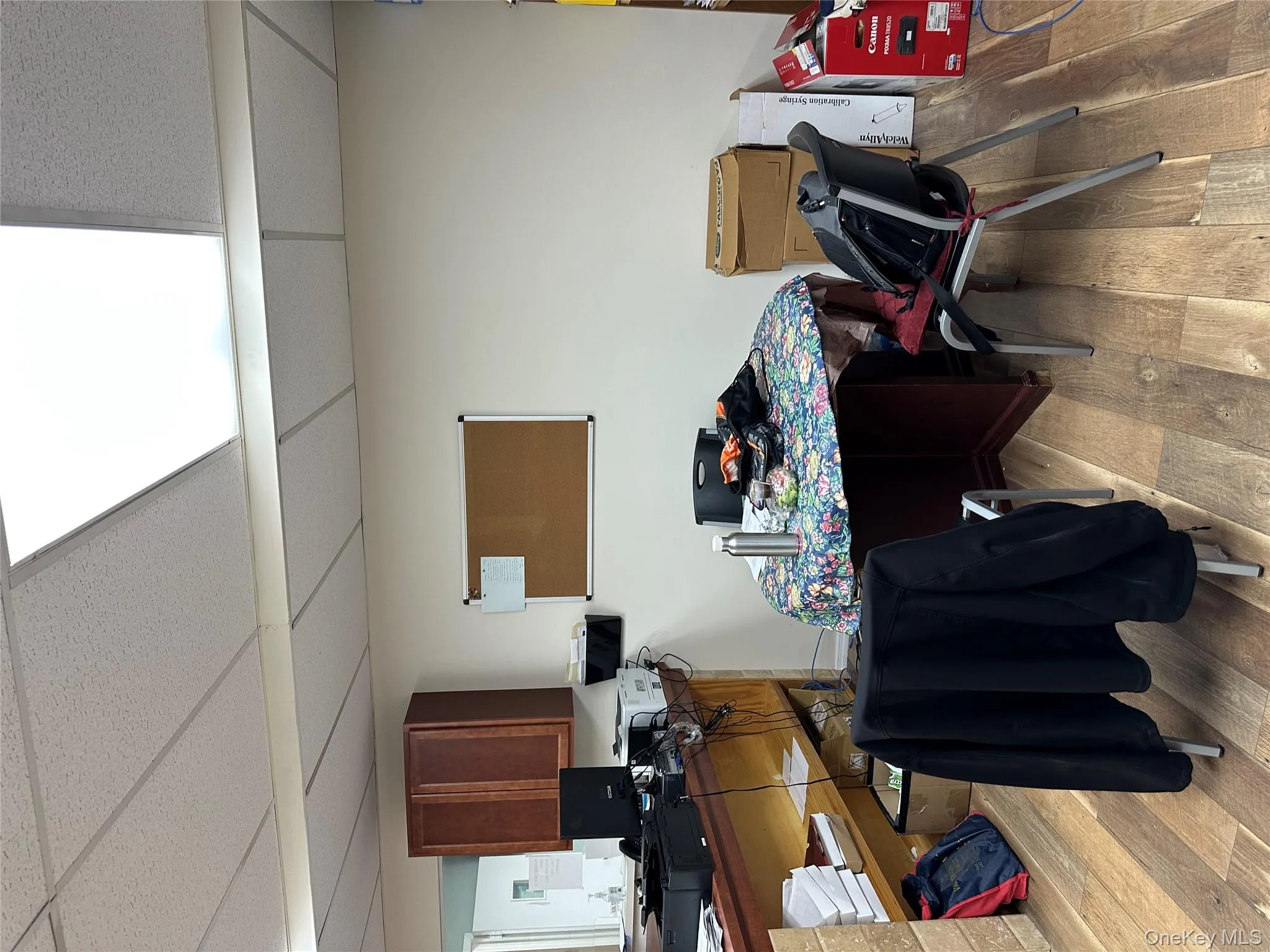 Office area featuring a paneled ceiling and light wood-type flooring Office area featuring a paneled ceiling and light wood-type flooring
