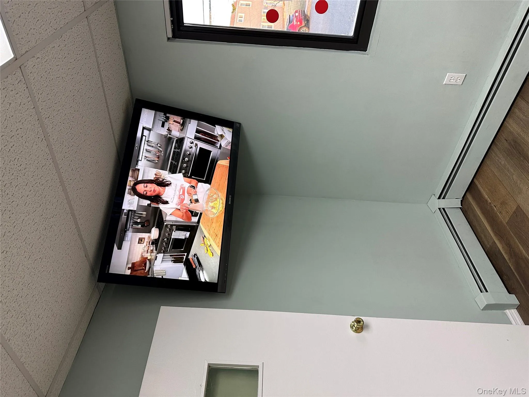 Detailed view of a drop ceiling, wood finished floors, and baseboard heating Detailed view of a drop ceiling, wood finished floors, and baseboard heating