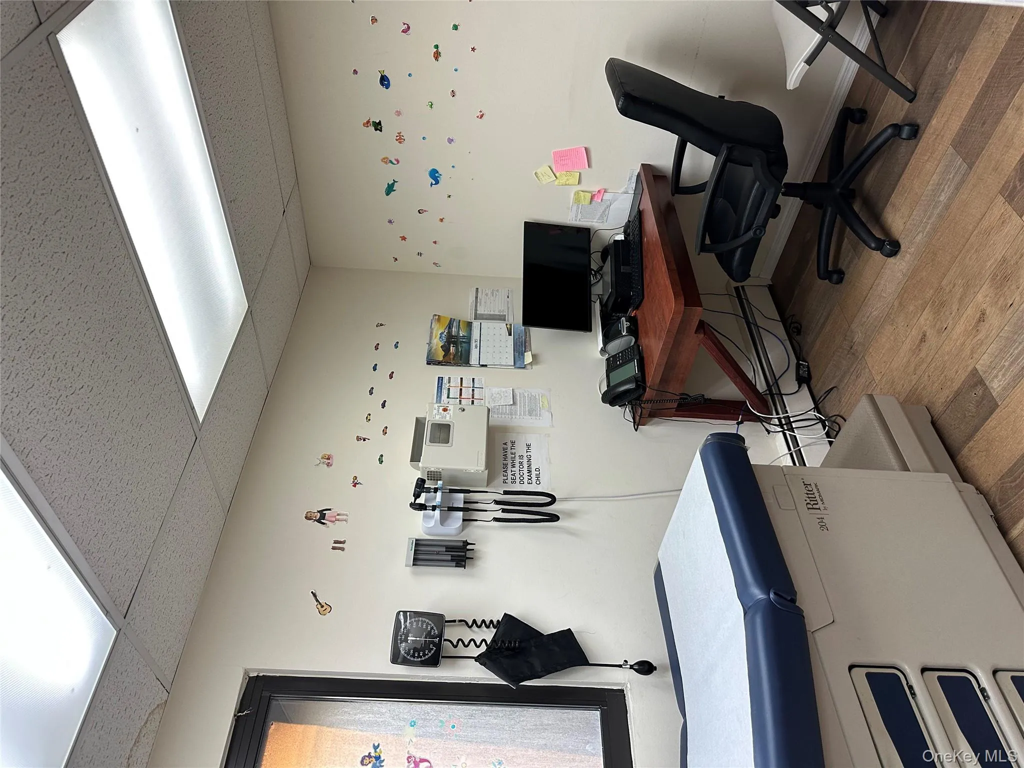 Office area featuring a drop ceiling and baseboard heating Office area featuring a drop ceiling and baseboard heating