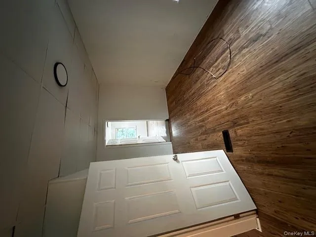Unfurnished room featuring a drop ceiling and dark wood-style flooring Unfurnished room featuring a drop ceiling and dark wood-style flooring