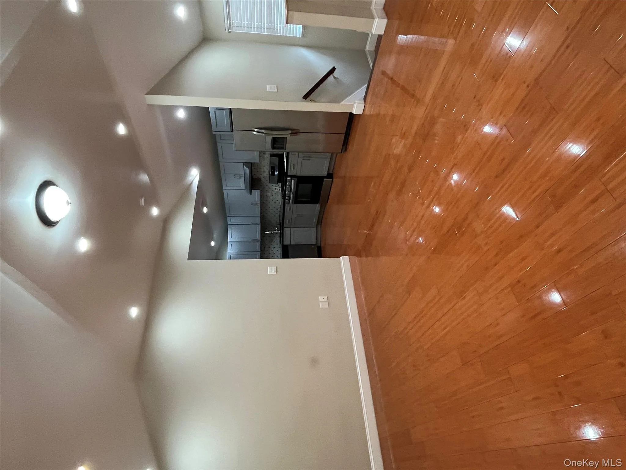 Unfurnished living room featuring light wood-style flooring and recessed lighting Unfurnished living room featuring light wood-style flooring and recessed lighting