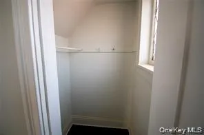 Walk in closet featuring lofted ceiling Walk in closet featuring lofted ceiling