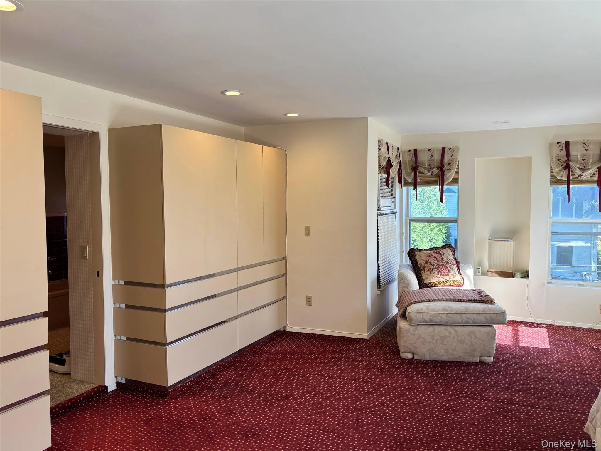 Living area with recessed lighting and dark colored carpet Living area with recessed lighting and dark colored carpet