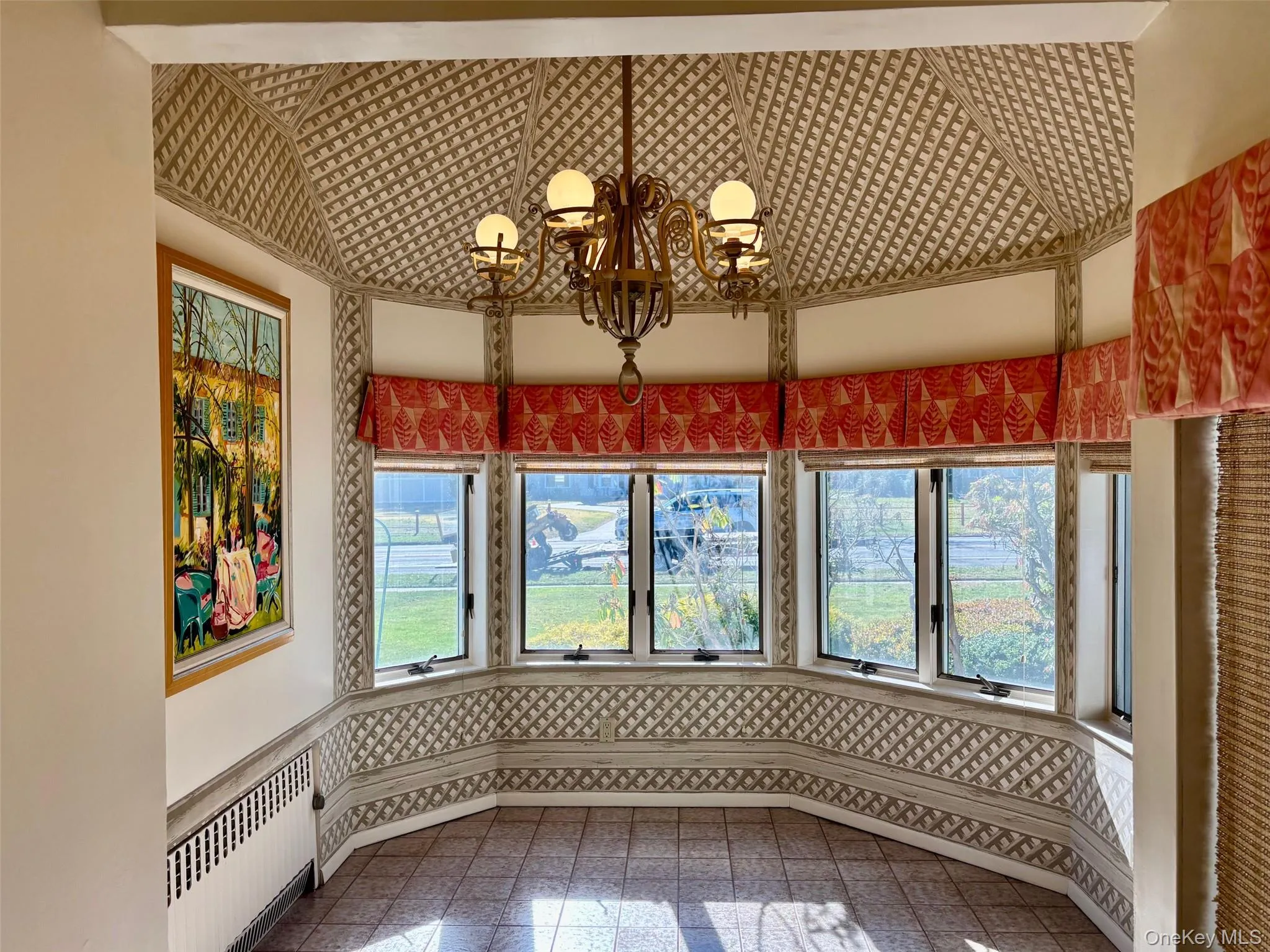 Unfurnished dining area with healthy amount of natural light, radiator, and wallpapered walls Unfurnished dining area with healthy amount of natural light, radiator, and wallpapered walls