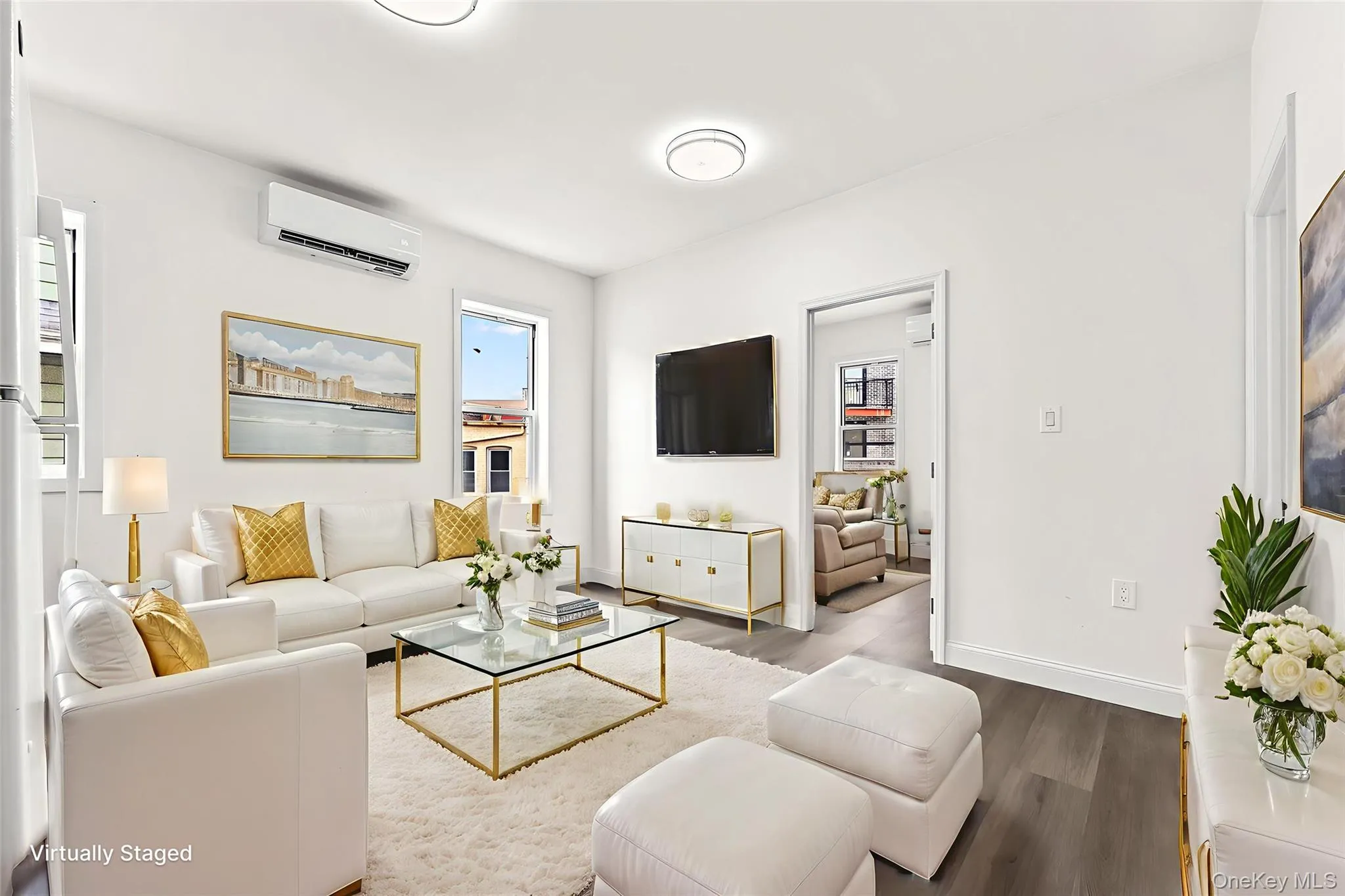 Living area with wood finished floors and an AC wall unit Living area with wood finished floors and an AC wall unit