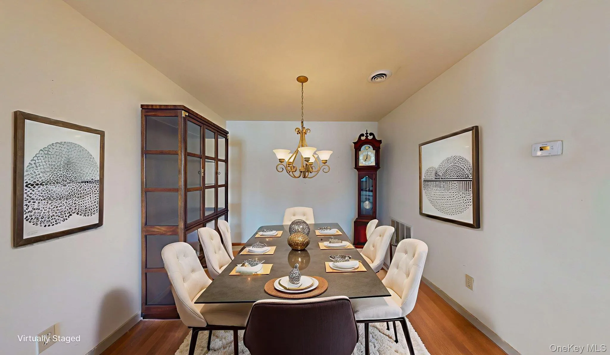 Dining room with a chandelier and wood finished floors Dining room with a chandelier and wood finished floors