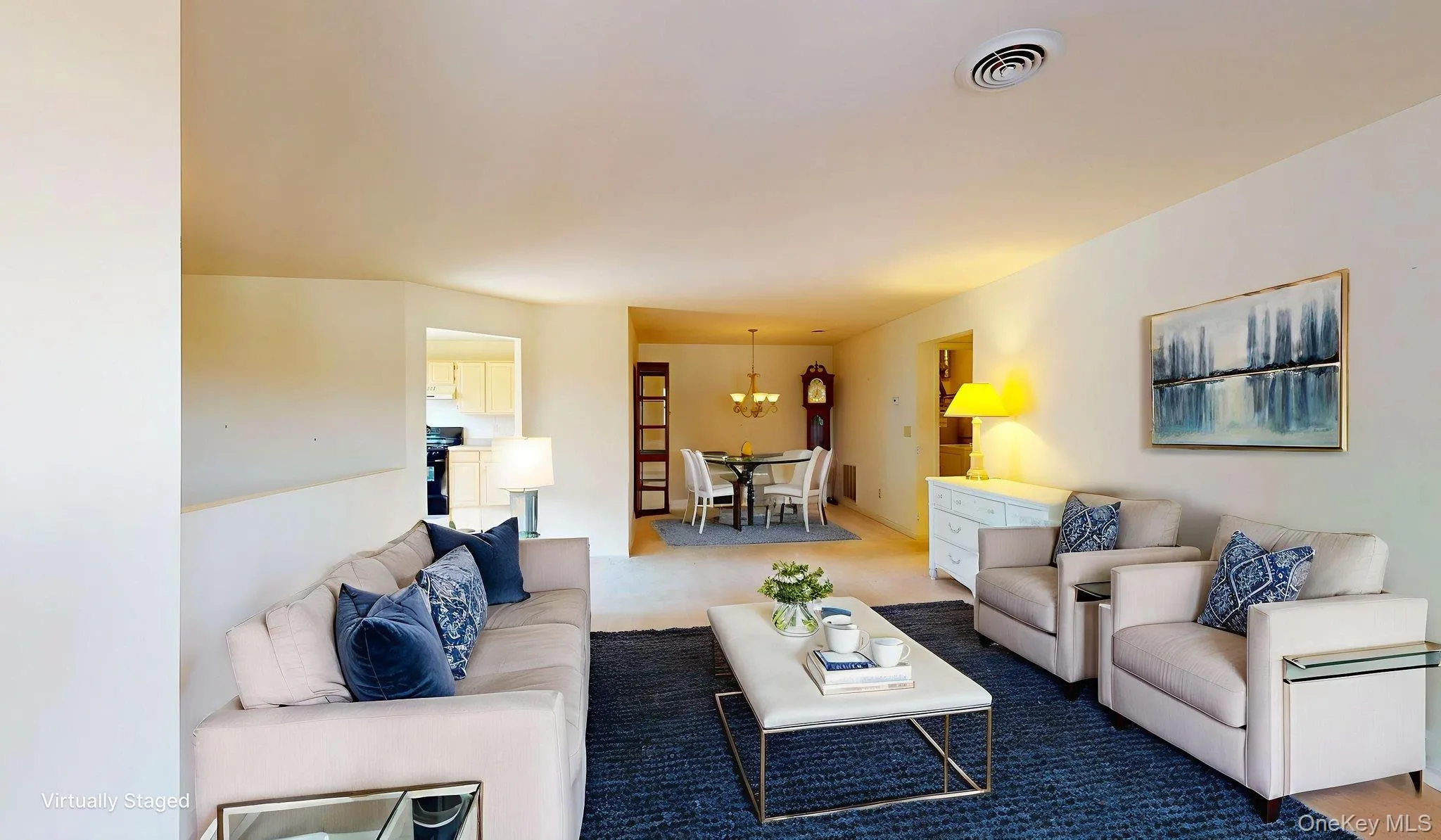 Carpeted living area with a chandelier Carpeted living area with a chandelier