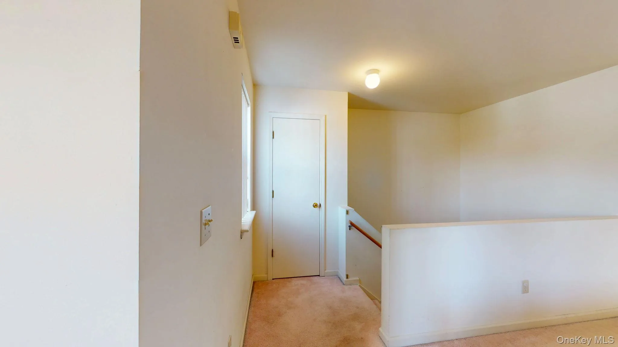 Hall with an upstairs landing and light carpet Hall with an upstairs landing and light carpet