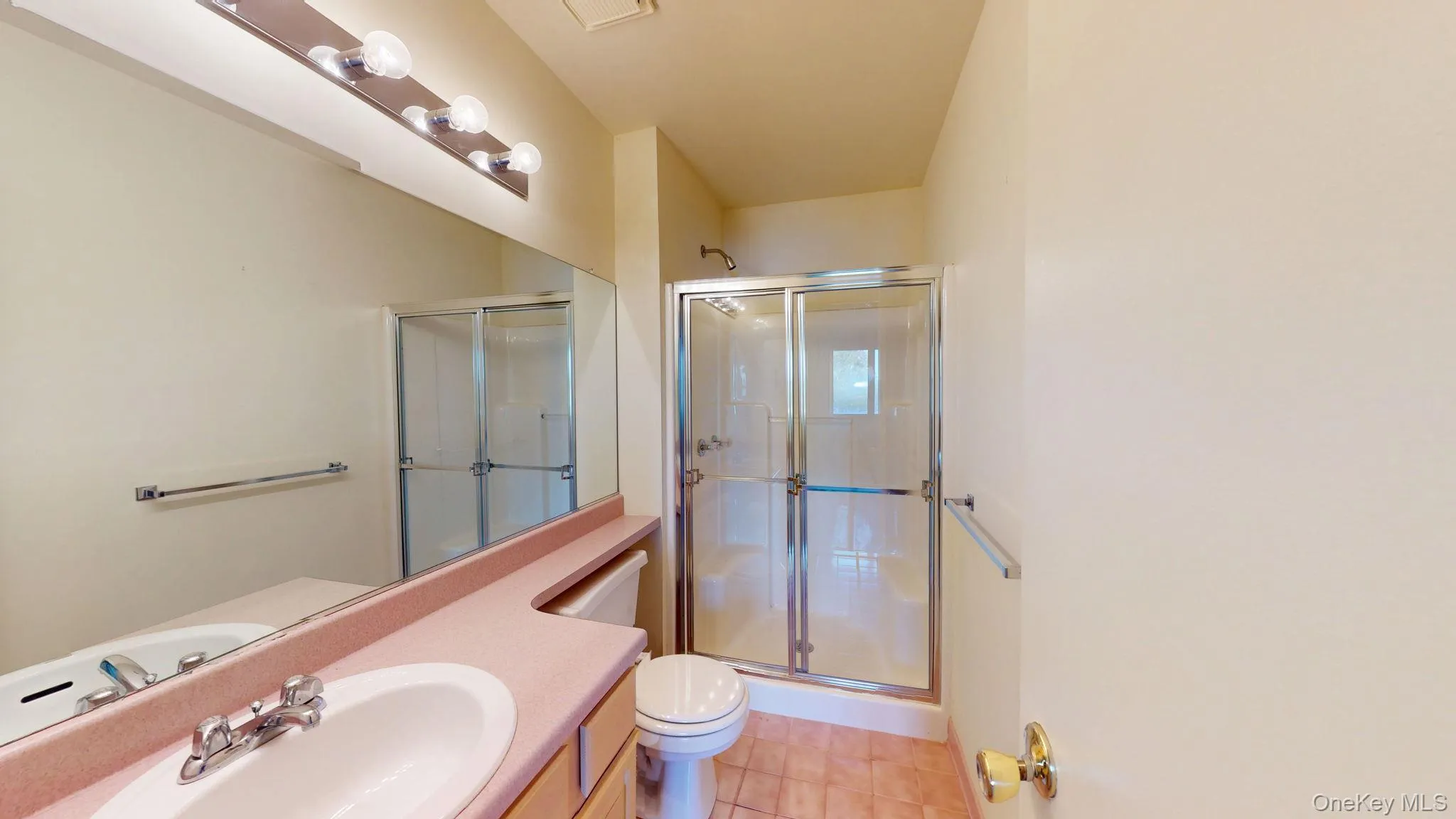 Full bathroom featuring vanity, light tile patterned floors, and a stall shower Full bathroom featuring vanity, light tile patterned floors, and a stall shower