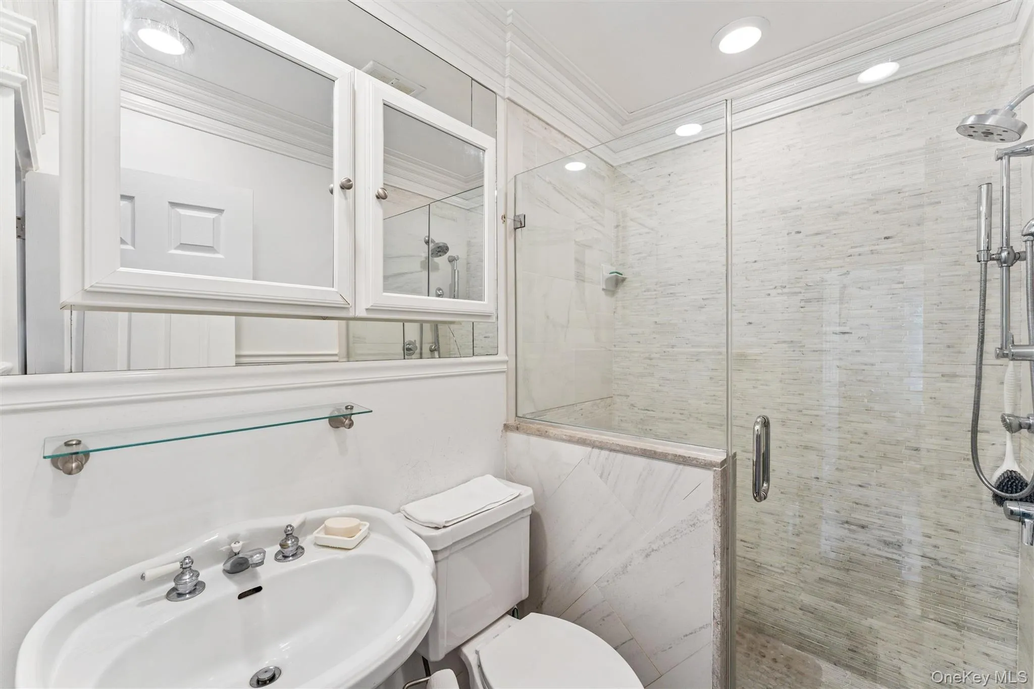 Full bath featuring ornamental molding, a shower stall, and recessed lighting Full bath featuring ornamental molding, a shower stall, and recessed lighting