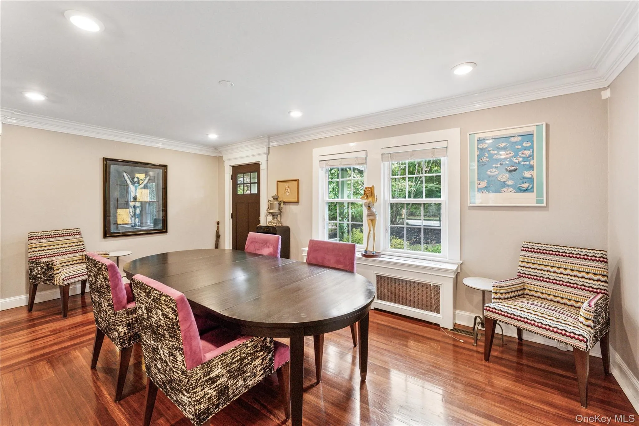 Dining area featuring crown molding, wood finished floors, plenty of natural light, radiator heating unit, and recessed lighting Dining area featuring crown molding, wood finished floors, plenty of natural light, radiator heating unit, and recessed lighting