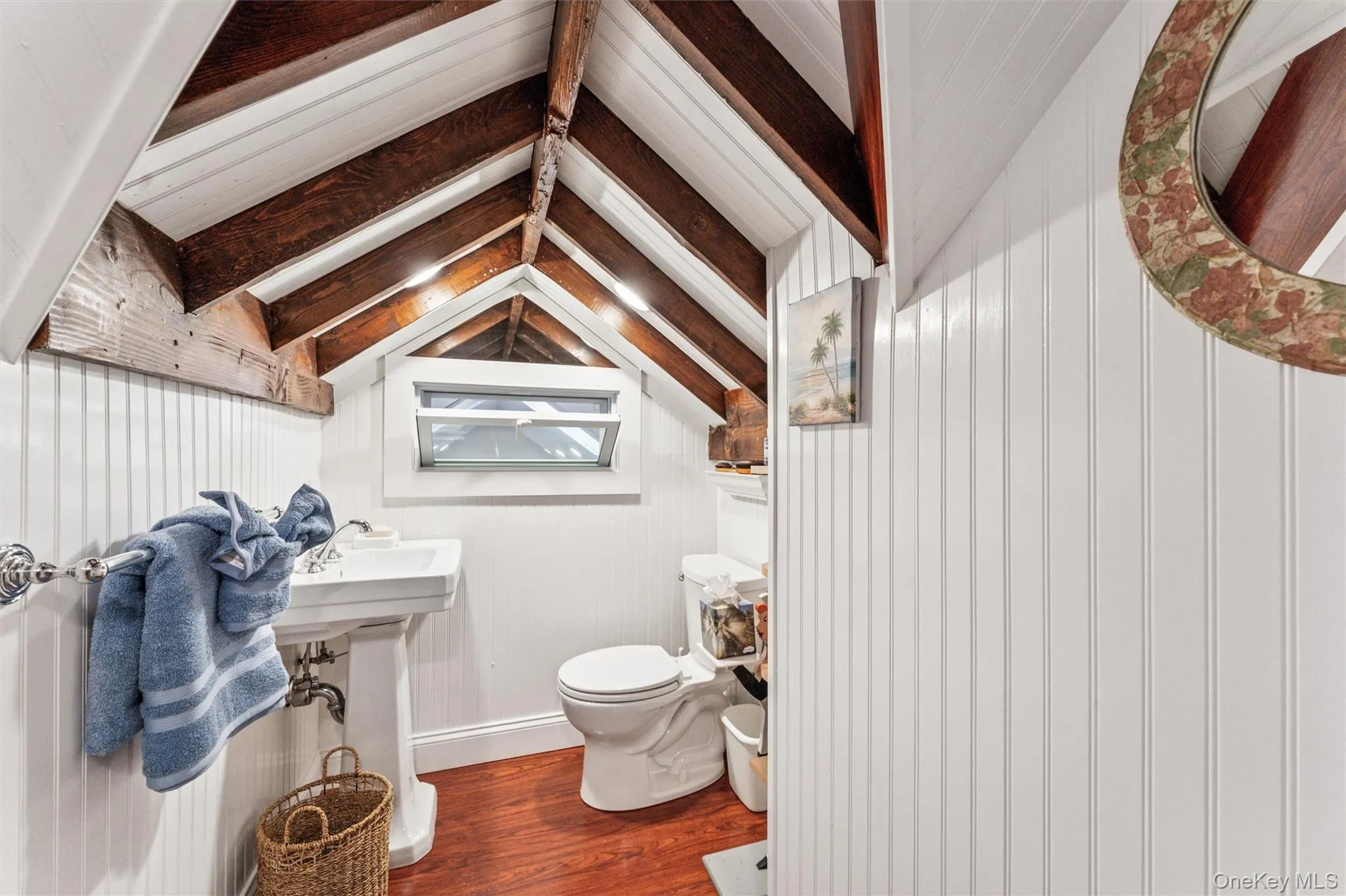 Half bath with dark wood-style flooring and wooden walls Half bath with dark wood-style flooring and wooden walls