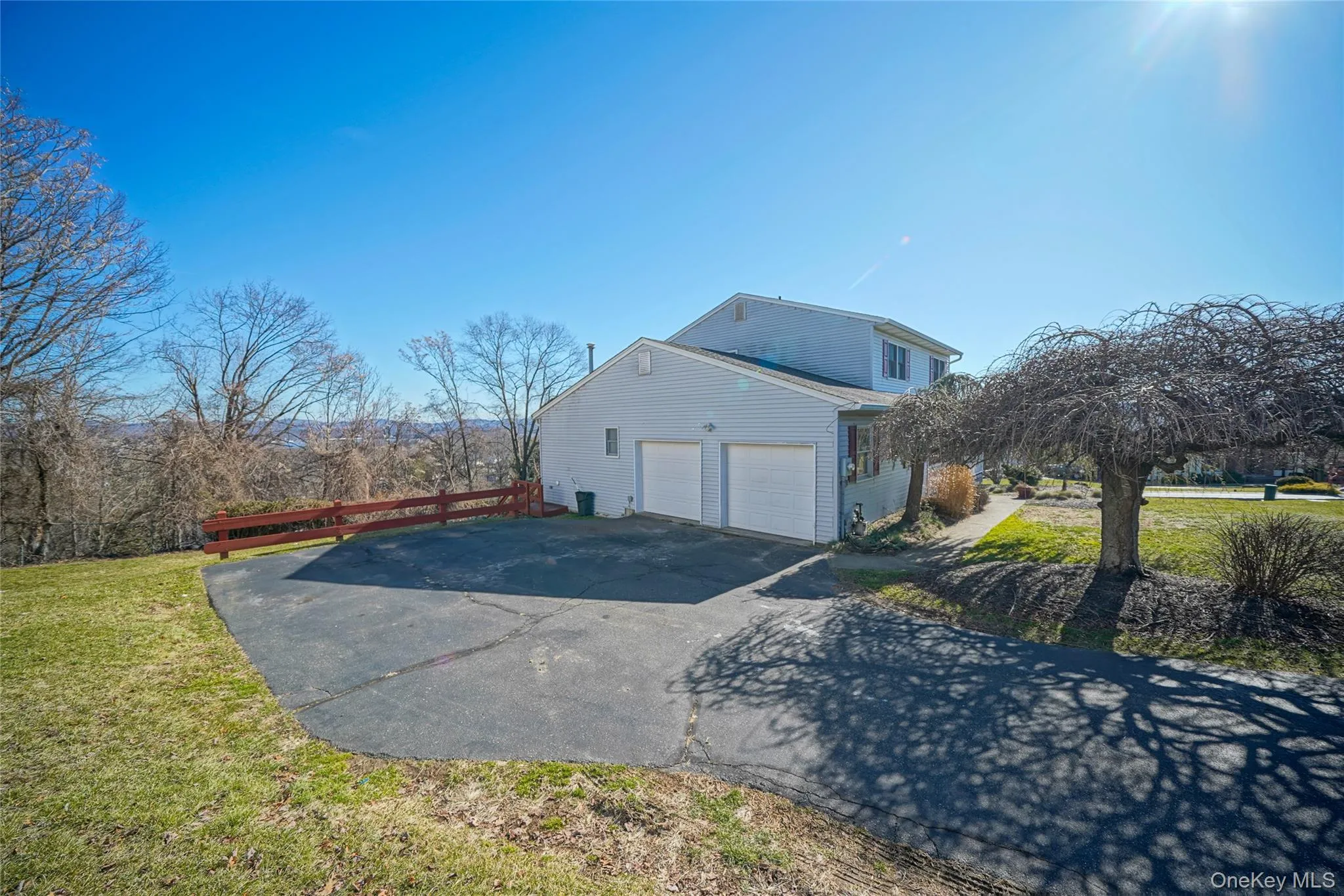 View of property exterior with driveway and a garage View of property exterior with driveway and a garage