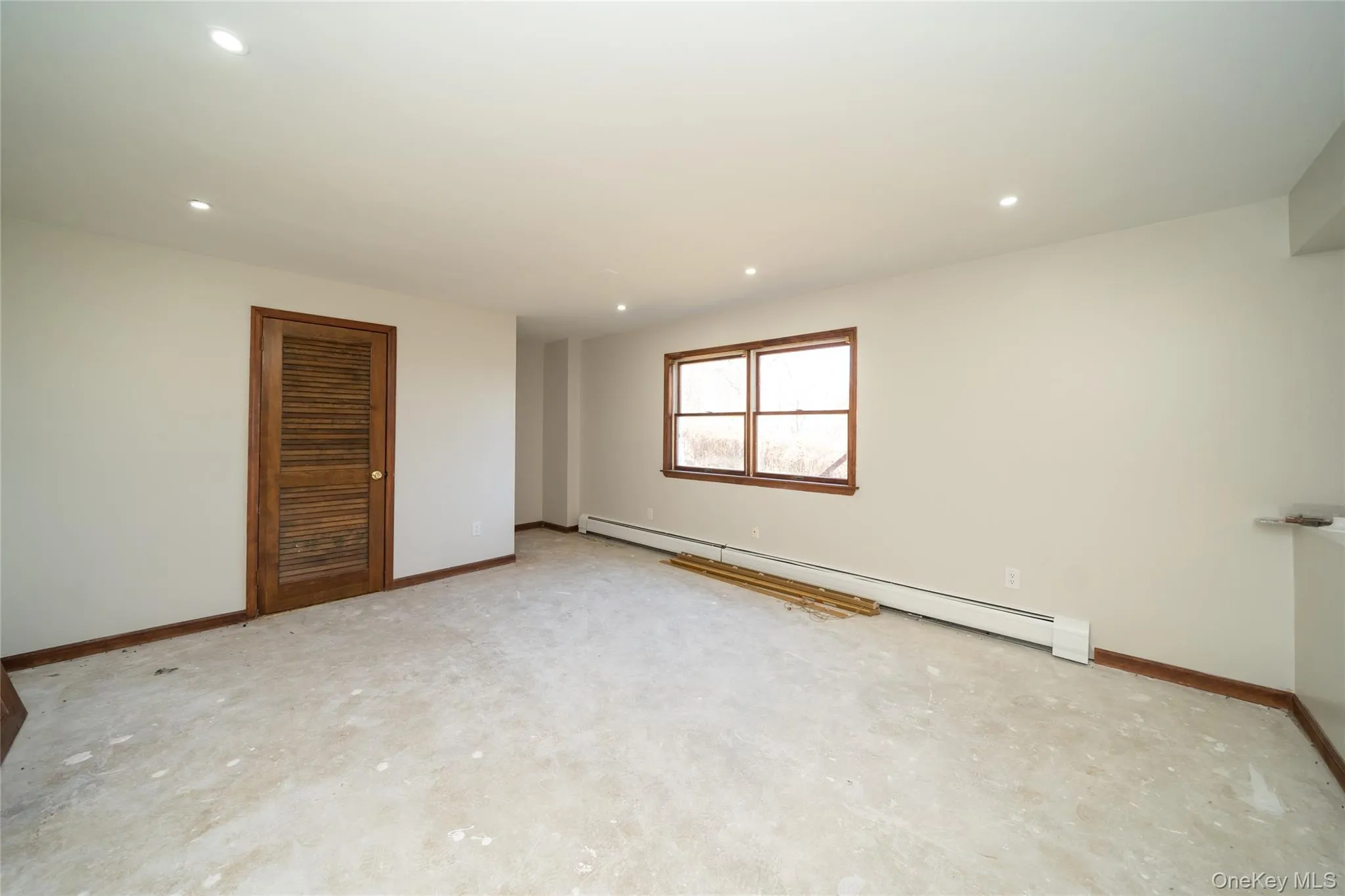 Unfurnished room featuring baseboard heating and recessed lighting Unfurnished room featuring baseboard heating and recessed lighting
