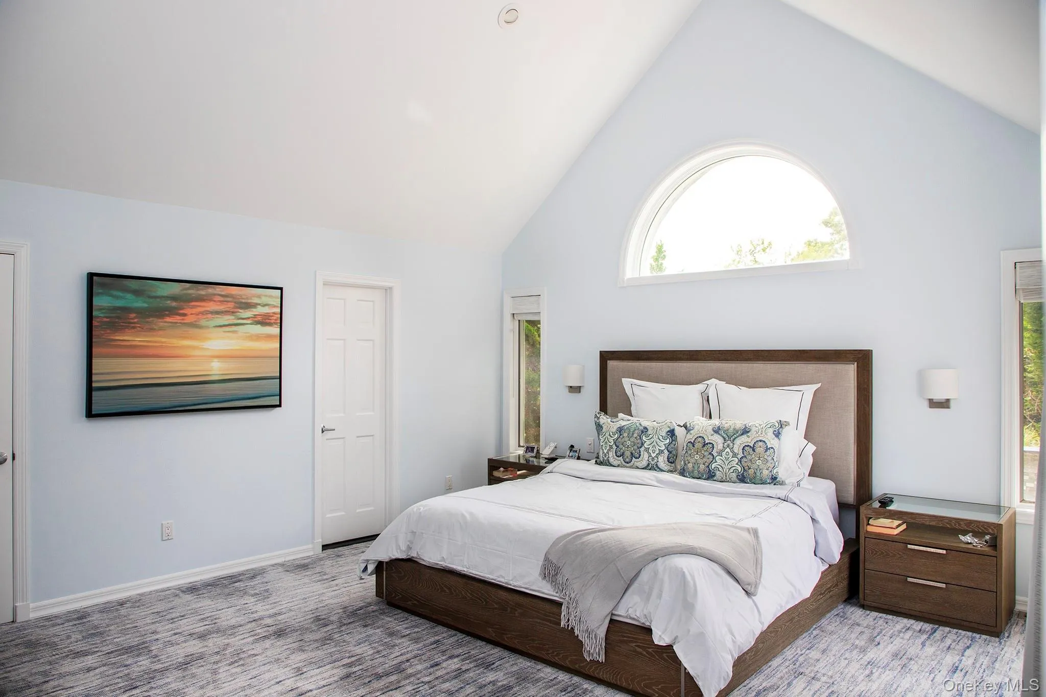 Bedroom with high vaulted ceiling and multiple windows Bedroom with high vaulted ceiling and multiple windows