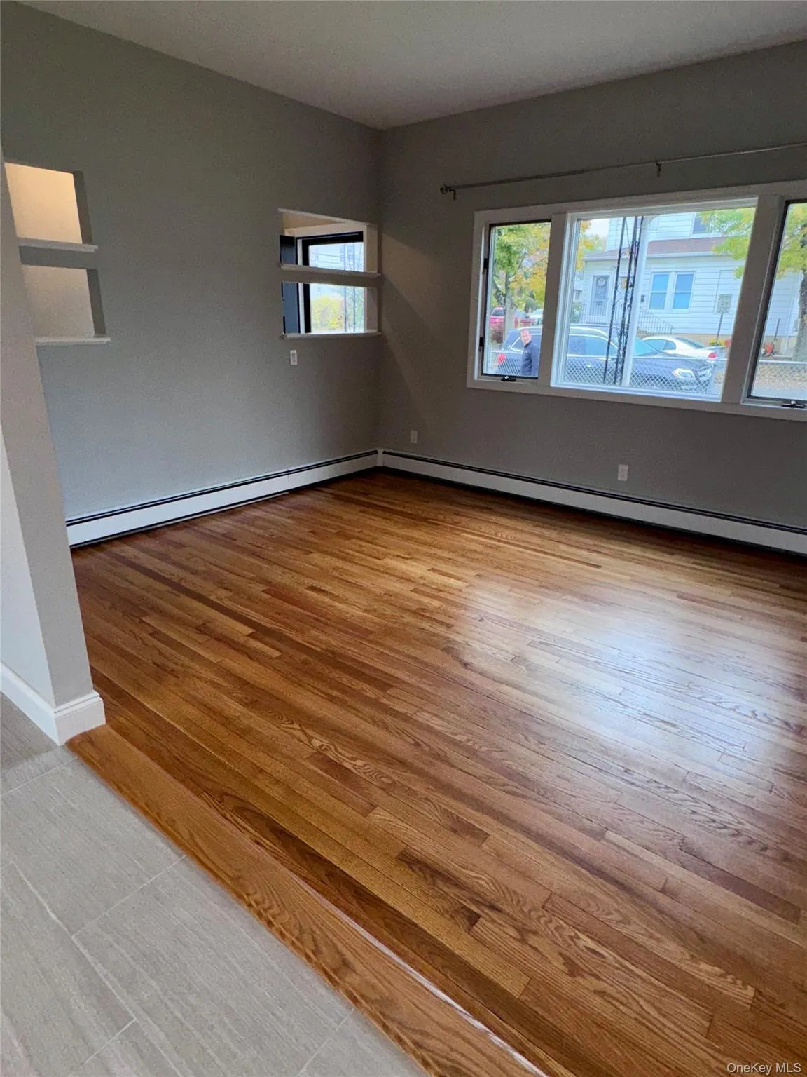 Living Room with light wood-style floors and baseboard heating Living Room with light wood-style floors and baseboard heating