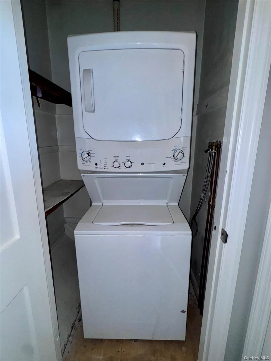 Washroom with stacked washer / dryer Washroom with stacked washer / dryer