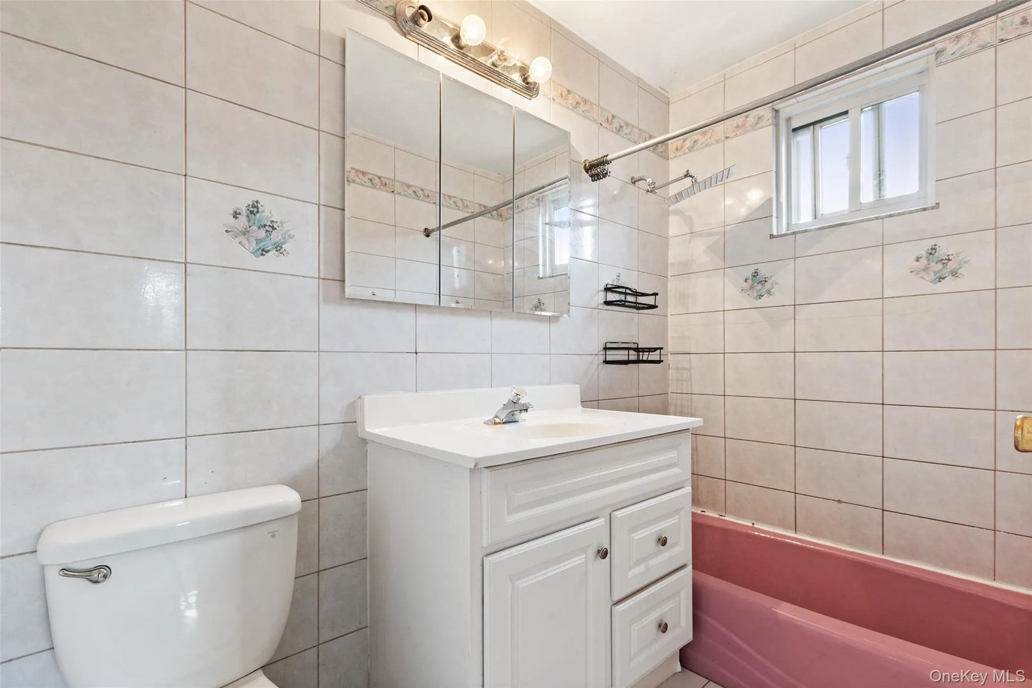 Full bathroom with tub / shower combination, vanity, and tile walls Full bathroom with tub / shower combination, vanity, and tile walls