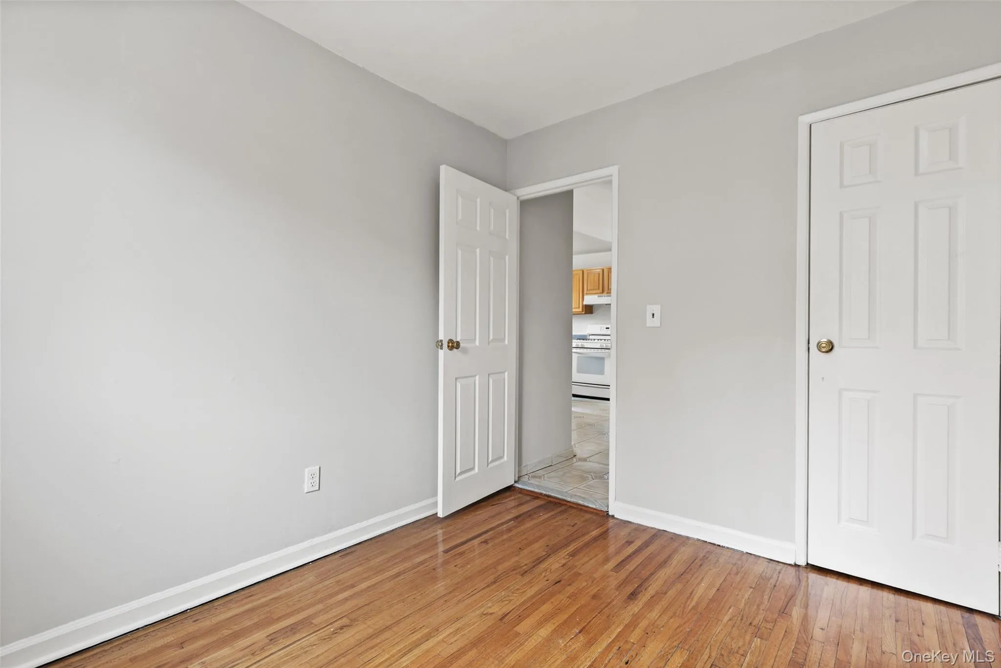 Unfurnished bedroom featuring baseboards and light wood finished floors Unfurnished bedroom featuring baseboards and light wood finished floors
