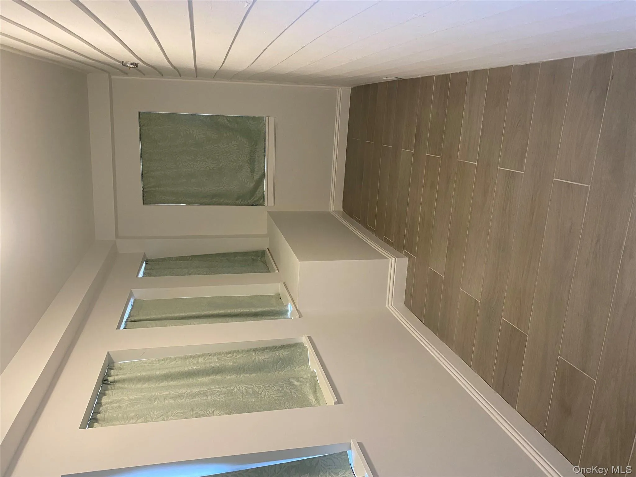 Hallway with baseboards and wood finish floors Hallway with baseboards and wood finish floors