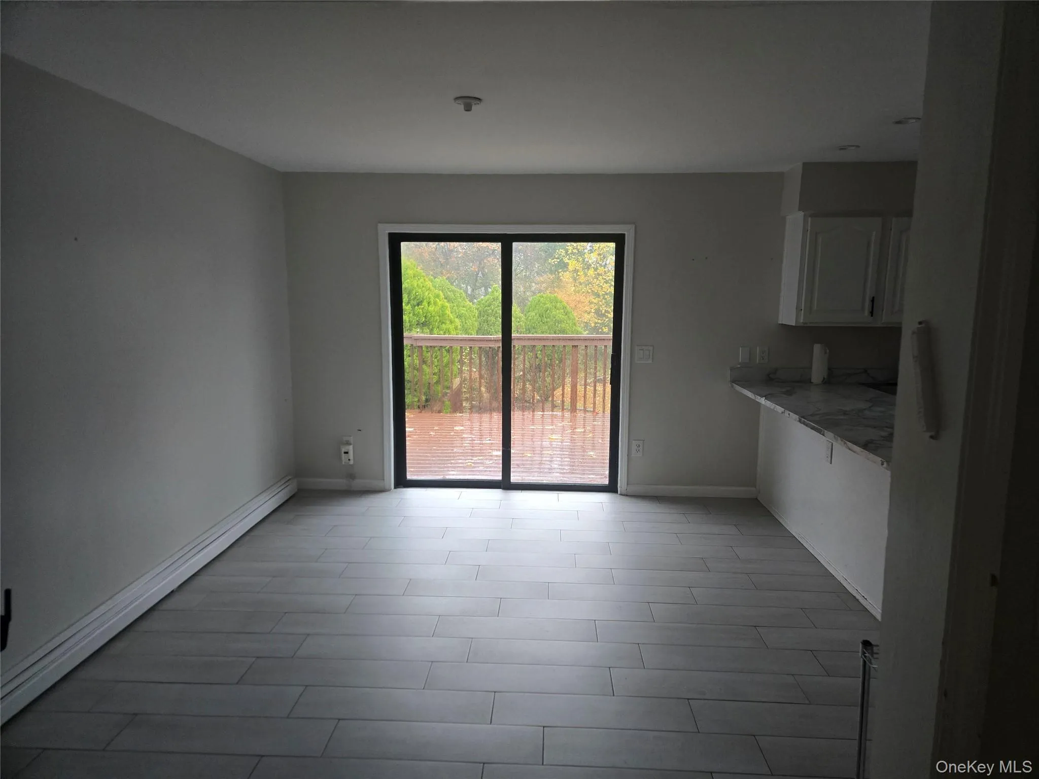 Unfurnished dining area with baseboard heating and light wood finished floors Unfurnished dining area with baseboard heating and light wood finished floors