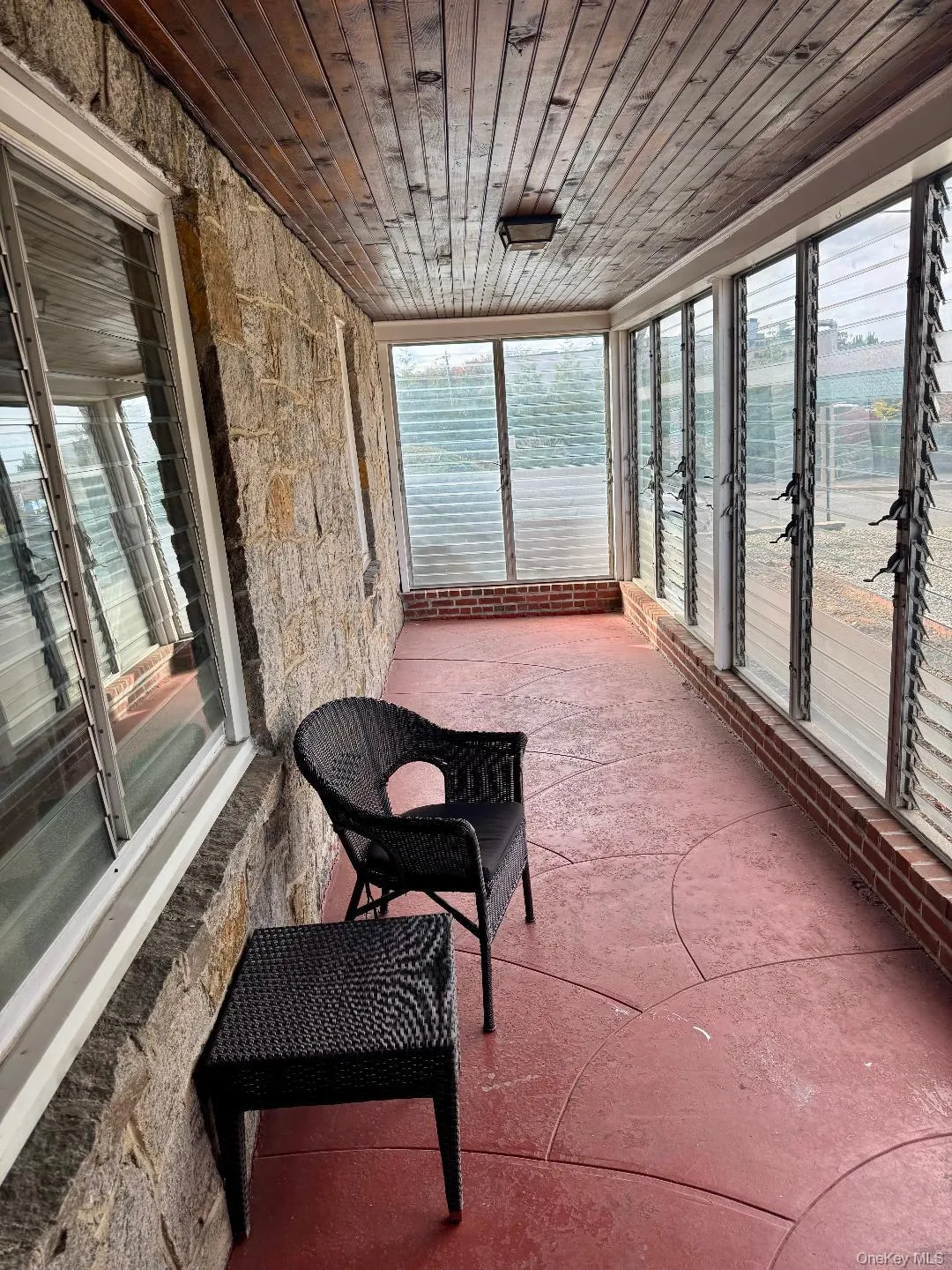 Sunroom with wooden ceiling and healthy amount of natural light Sunroom with wooden ceiling and healthy amount of natural light