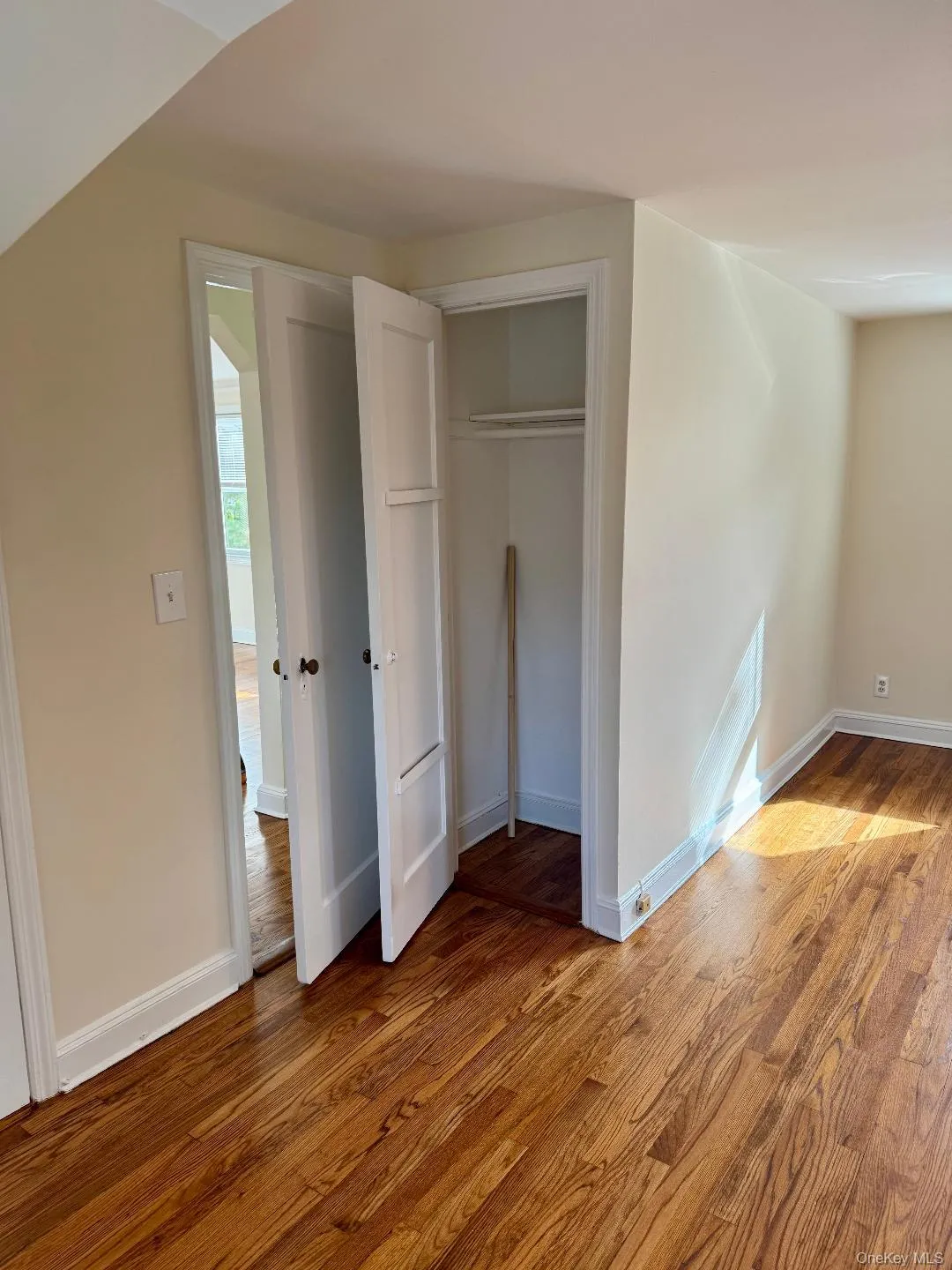 Unfurnished bedroom with wood finished floors and a closet Unfurnished bedroom with wood finished floors and a closet