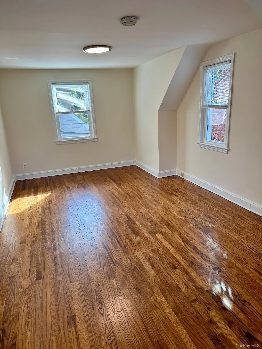 Additional living space featuring healthy amount of natural light and wood finished floors Additional living space featuring healthy amount of natural light and wood finished floors