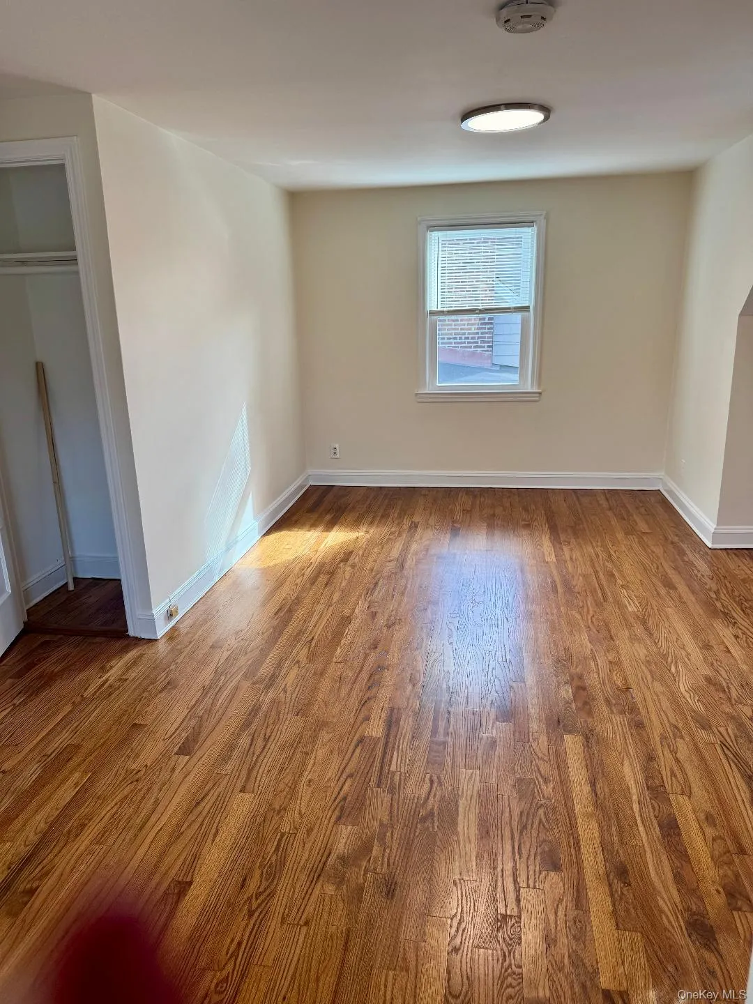 Spare room with light wood-style flooring and baseboards Spare room with light wood-style flooring and baseboards