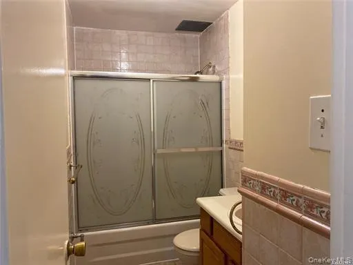 Bathroom with enclosed tub / shower combo and vanity Bathroom with enclosed tub / shower combo and vanity