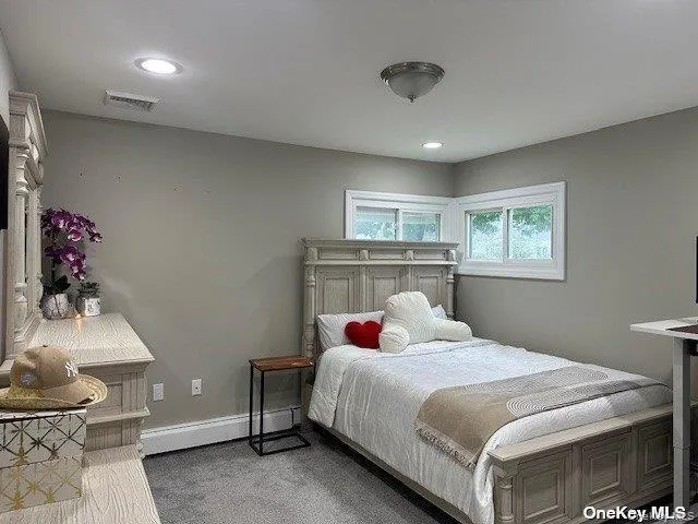 Bedroom featuring carpet floors, a baseboard radiator, and recessed lighting Bedroom featuring carpet floors, a baseboard radiator, and recessed lighting