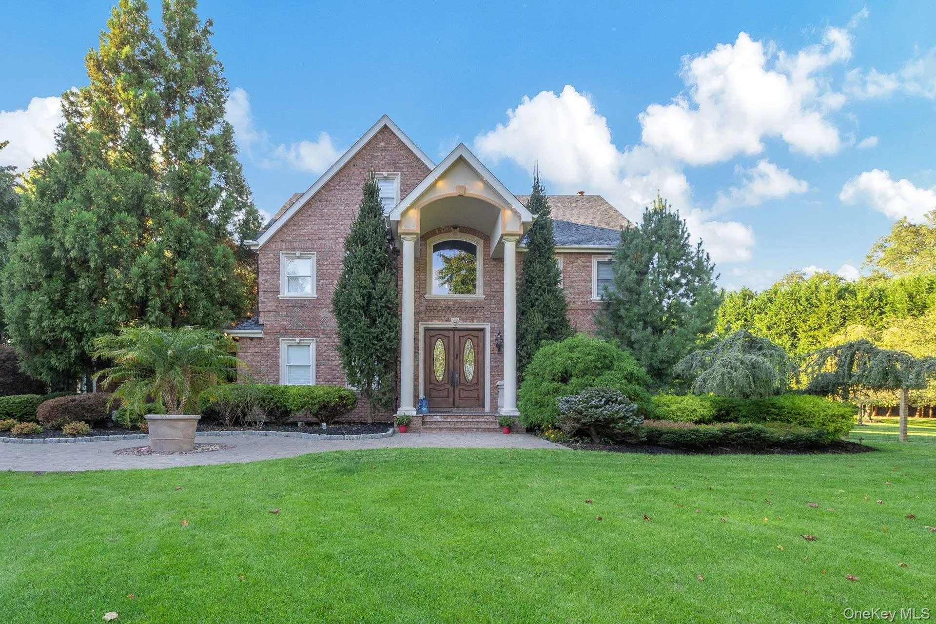 Traditional-style house featuring a front lawn and brick siding Traditional-style house featuring a front lawn and brick siding