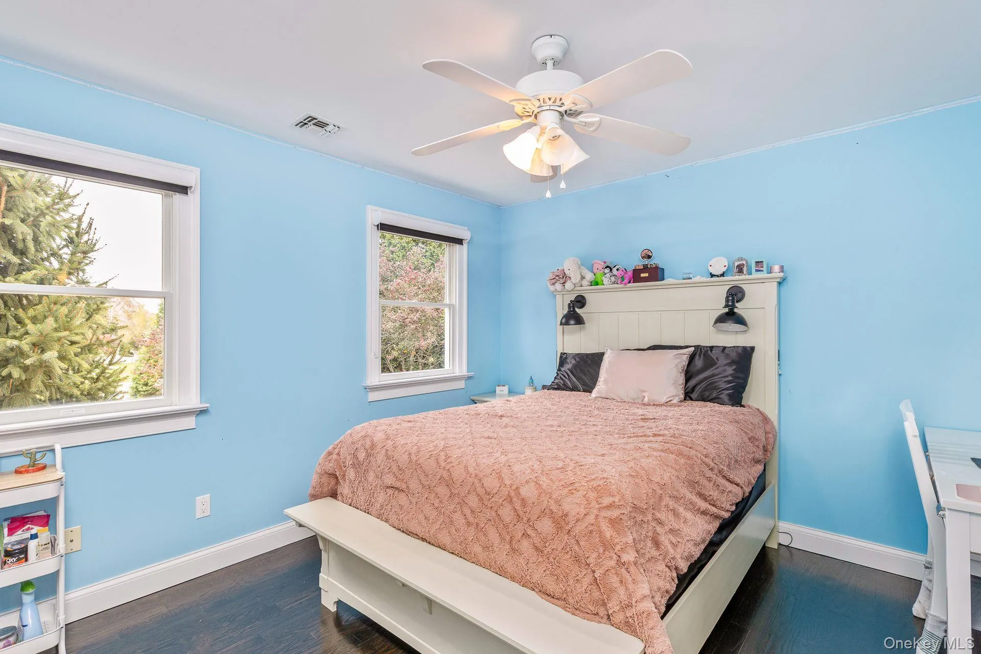 Bedroom featuring dark wood finished floors and a ceiling fan Bedroom featuring dark wood finished floors and a ceiling fan
