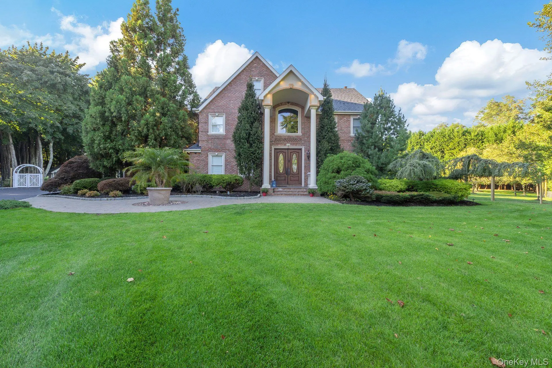 Traditional-style home with a front lawn and brick siding Traditional-style home with a front lawn and brick siding