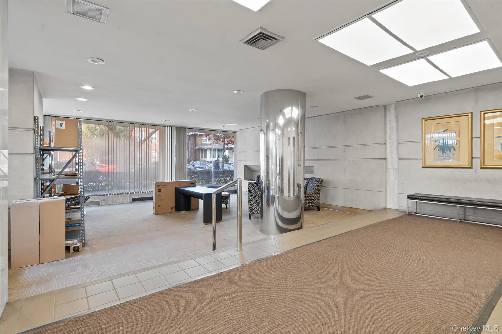 Building lobby featuring floor to ceiling windows and recessed lighting Building lobby featuring floor to ceiling windows and recessed lighting