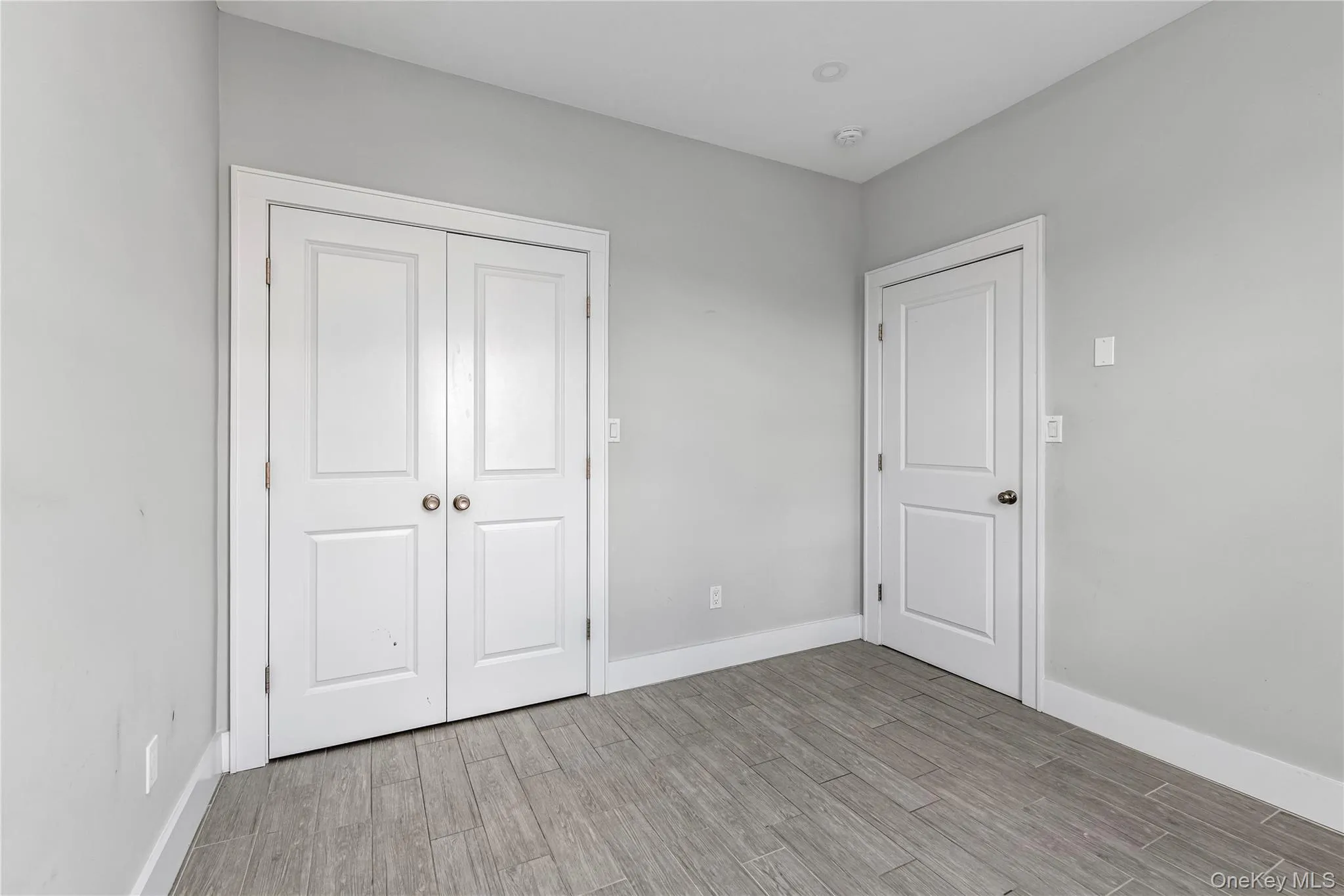 Unfurnished bedroom featuring light wood-style flooring and a closet Unfurnished bedroom featuring light wood-style flooring and a closet