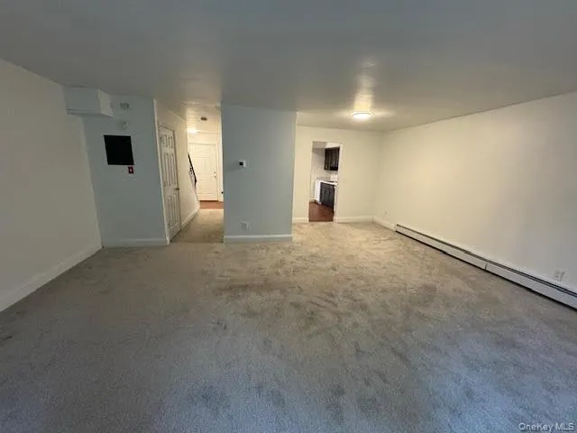 Empty room with carpet and baseboards Empty room with carpet and baseboards